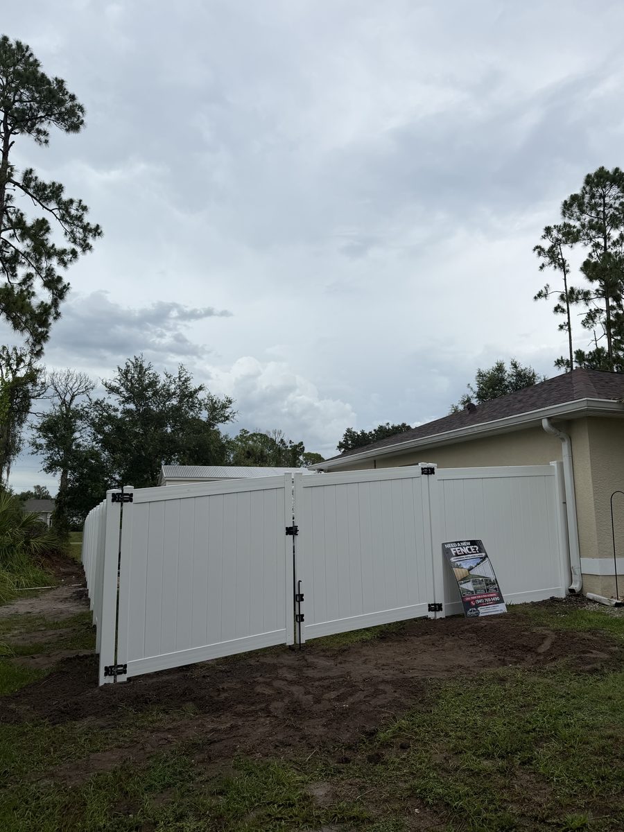 White vinyl fence with double gate by Rodgers Services